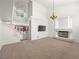 Spacious living room with fireplace, modern chandelier, and neutral carpet at 8733 Country Pines Ave, Las Vegas, NV 89129