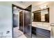 Modern bathroom with a double sink vanity, and an open entrance to the walk-in closet area at 8925 W Flamingo Rd # 117, Las Vegas, NV 89147