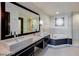 Spa-like bathroom featuring double sinks, a soaking tub, and a walk-in glass shower for a relaxing retreat at 8925 W Flamingo Rd # 117, Las Vegas, NV 89147