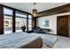 Light-filled bedroom with large windows, seating area and bed with an ensuite bath for additional luxury at 8925 W Flamingo Rd # 117, Las Vegas, NV 89147