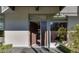 Inviting modern home featuring an open front door and lush landscaping enhancing the property's curb appeal at 8925 W Flamingo Rd # 117, Las Vegas, NV 89147