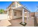Back patio with pergola featuring desert landscaping and mature trees at 9073 Spoonbill Ridge Pl, Las Vegas, NV 89143