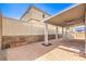 Spacious covered back patio with brick detailing and fan at 9073 Spoonbill Ridge Pl, Las Vegas, NV 89143