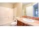 Bathroom with large mirror, tub, tiled shower and tile countertop at 9073 Spoonbill Ridge Pl, Las Vegas, NV 89143