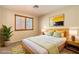 Bright bedroom featuring a comfortable bed with stylish bedding and a large window at 9073 Spoonbill Ridge Pl, Las Vegas, NV 89143