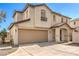 Two-story home with a two-car garage, desert landscaping, and a welcoming covered front porch at 9073 Spoonbill Ridge Pl, Las Vegas, NV 89143