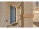 Close-up of the blue front door with desert landscaping and stylish accents at 9073 Spoonbill Ridge Pl, Las Vegas, NV 89143