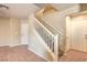 Hallway with a stairway, white trim, neutral walls, and tile flooring leading to other rooms at 9073 Spoonbill Ridge Pl, Las Vegas, NV 89143