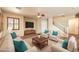 Bright living room featuring neutral tones, modern decor, and stylish wood laminate flooring at 9073 Spoonbill Ridge Pl, Las Vegas, NV 89143