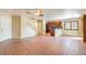 Spacious living room with tile flooring that connects to the open kitchen and dining area at 9073 Spoonbill Ridge Pl, Las Vegas, NV 89143