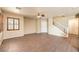 Bright living room with tile flooring, ceiling fan, and staircase leading to the upper level at 9073 Spoonbill Ridge Pl, Las Vegas, NV 89143