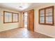 Living room featuring stylish tile flooring, shutters, and access to the outdoor patio at 9073 Spoonbill Ridge Pl, Las Vegas, NV 89143