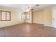 Open living room featuring stylish tile flooring, shutters, and neutral paint at 9073 Spoonbill Ridge Pl, Las Vegas, NV 89143