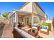 Cozy covered patio with stylish seating and a dining area perfect for outdoor entertaining at 9073 Spoonbill Ridge Pl, Las Vegas, NV 89143