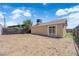 Vast backyard space featuring a dirt landscape and a back house with sliding glass door at 952 Balzar Ave, Las Vegas, NV 89106