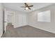 Bright bedroom featuring carpeted floors, a ceiling fan, and closet space at 952 Balzar Ave, Las Vegas, NV 89106