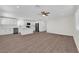 Open-concept living space features a ceiling fan, wood floors, and seamlessly connects the kitchen and living areas at 952 Balzar Ave, Las Vegas, NV 89106