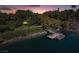Aerial view of a private dock and boat on a tranquil lake surrounded by lush greenery at 1 Via Mira Monte, Henderson, NV 89011