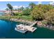 Stunning aerial view of a lakefront home with a private dock, boat, and lush landscaping at 1 Via Mira Monte, Henderson, NV 89011
