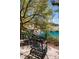 Secluded backyard retreat with wrought iron chairs and a scenic view of a tranquil blue pond at 1 Via Mira Monte, Henderson, NV 89011