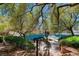 Lush backyard landscape with wrought iron railings leading to a bridge spanning a serene blue waterway at 1 Via Mira Monte, Henderson, NV 89011