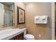 Bathroom featuring a tiled shower, dark wood vanity, and decorative accents at 1 Via Mira Monte, Henderson, NV 89011