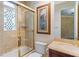 Bathroom with a shower over the tub, detailed wall design, and a sink with dark wood cabinetry at 1 Via Mira Monte, Henderson, NV 89011