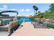 Private dock with boat, lounge chairs, and waterfront access with views of mountains in the background at 1 Via Mira Monte, Henderson, NV 89011