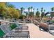 Luxury waterfront property featuring a private dock with lounge chairs, boat, and lush landscaping at 1 Via Mira Monte, Henderson, NV 89011