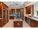 Well-appointed kitchen featuring stainless steel appliances, dark wood cabinetry, and tile flooring at 1 Via Mira Monte, Henderson, NV 89011