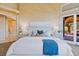 Stylish main bedroom featuring soft lighting, a comfortable bed, and a door to the outside at 1 Via Mira Monte, Henderson, NV 89011