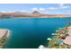 Panoramic view of a lakefront property with private docks, luxury homes, and mountain scenery at 1 Via Mira Monte, Henderson, NV 89011