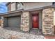 Close-up featuring a red front door with stone accents and a paved driveway at 1011 Gentle Swan St # Lot 697, Henderson, NV 89011