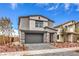 Attractive two-story home with a gray exterior, stone accents, and well-maintained landscaping at 1011 Gentle Swan St # Lot 697, Henderson, NV 89011