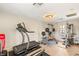 Home gym featuring exercise equipment, natural light, and wood floors at 10301 Orkiney Dr, Las Vegas, NV 89144