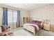 A cozy bedroom with butterfly-themed wallpaper and a comfortable daybed at 10301 Orkiney Dr, Las Vegas, NV 89144