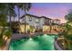 Elegant home exterior with a sparkling pool and lush landscaping, offering privacy and style at 10301 Orkiney Dr, Las Vegas, NV 89144