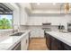 Bright kitchen featuring white cabinetry, hexagon tile backsplash, stainless appliances, and island, offering a chef's dream space at 10301 Orkiney Dr, Las Vegas, NV 89144