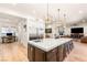 This spacious kitchen is perfect for entertaining, featuring a large island with seating that opens into a bright and airy living area at 10301 Orkiney Dr, Las Vegas, NV 89144