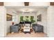 Inviting living room featuring a piano, stylish decor, and large windows, ideal for music and relaxation at 10301 Orkiney Dr, Las Vegas, NV 89144