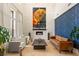 Bright living room featuring modern furnishings, a fireplace, and accent wall, designed for comfortable living at 10301 Orkiney Dr, Las Vegas, NV 89144