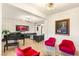 Elegant living room with a piano, modern lighting, and bold accents, perfect for both relaxing and entertaining at 10301 Orkiney Dr, Las Vegas, NV 89144