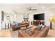 Cozy living room featuring a stone accent wall, fireplace, hardwood floors, and comfortable leather seating, perfect for relaxation at 10301 Orkiney Dr, Las Vegas, NV 89144