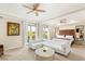 Spacious main bedroom with seating area, tray ceilings, and outdoor balcony access at 10301 Orkiney Dr, Las Vegas, NV 89144