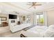 Expansive main bedroom featuring a fireplace, a TV, and outdoor access at 10301 Orkiney Dr, Las Vegas, NV 89144