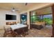 Covered patio with outdoor dining, fireplace, and plush seating area for relaxation at 10301 Orkiney Dr, Las Vegas, NV 89144