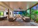 Stylish outdoor living area with a fire pit, seating, and a built-in bar at 10301 Orkiney Dr, Las Vegas, NV 89144