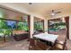 Inviting outdoor space with a dining area, lounge seating, and serene backyard views at 10301 Orkiney Dr, Las Vegas, NV 89144