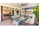Expansive covered patio with a fire pit, TV, comfortable seating, and an outdoor kitchen, perfect for entertaining at 10301 Orkiney Dr, Las Vegas, NV 89144