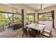 Spacious covered patio with dining and lounge areas, offering stunning views of the backyard and pool at 10301 Orkiney Dr, Las Vegas, NV 89144